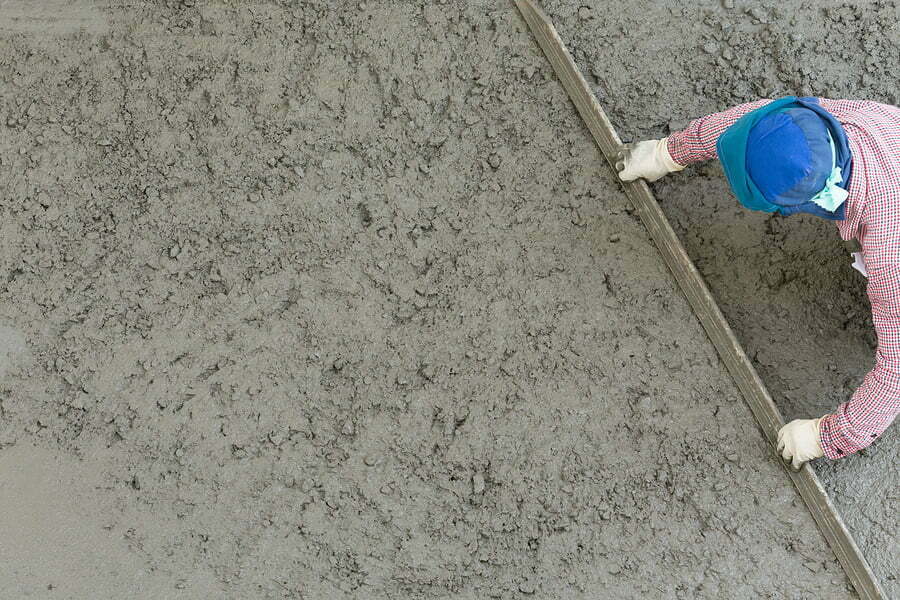plasterer concrete cement worker plastering flooring of house construction